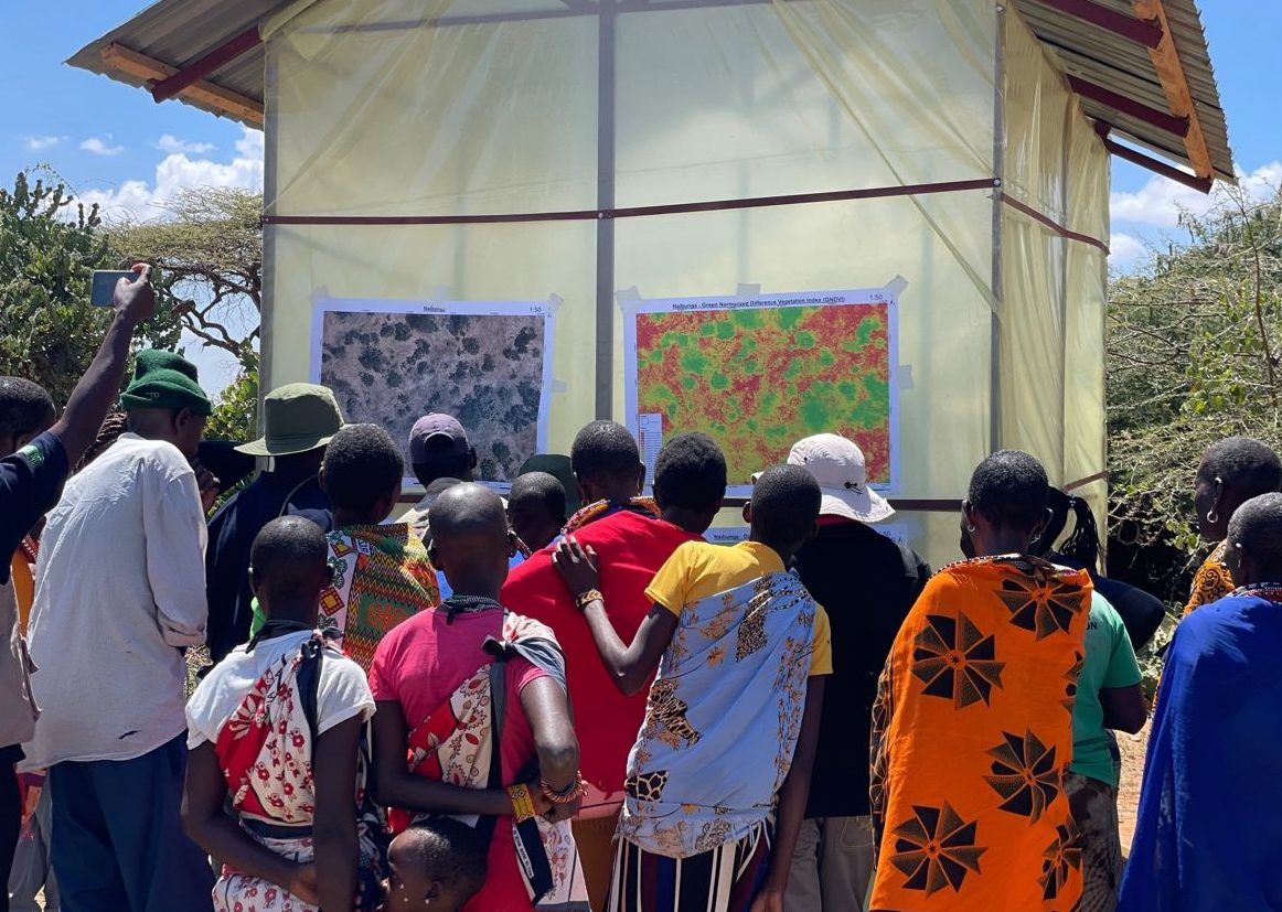 Community members viewing a vegetation index map derived from drone imagery